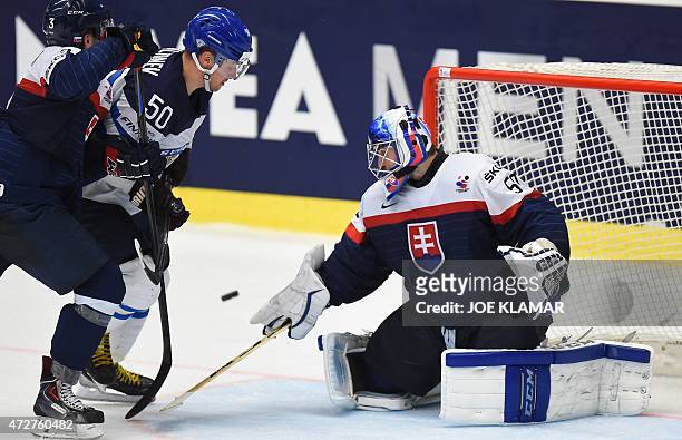 Slovakia's goaltender Jan Laco stops Finland's Juhamatti Aaltonen during the group B preliminary round match between Finland and Slovakia of the IIHF...