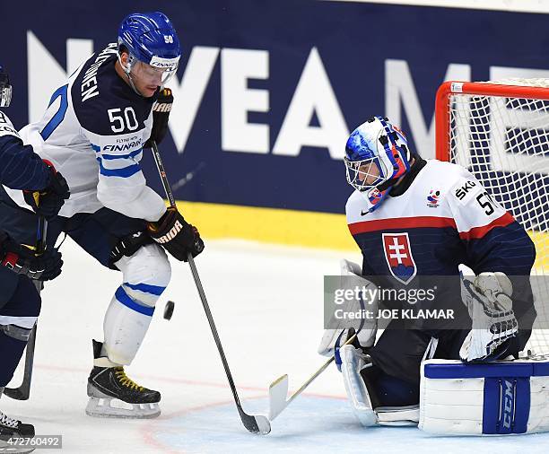 Slovakia's goaltender Jan Laco stops Finland's Juhamatti Aaltonen during the preliminary round between Finland and Slovakia during the IIHF Ice...