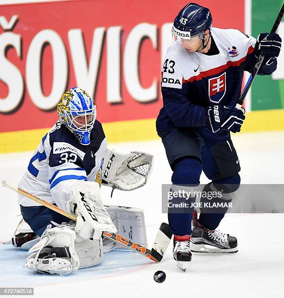 Finland's goalkeeper Juuse Saros stops Slovakia's Tomas Surovy during the preliminary round between Finland and Slovakia during the IIHF Ice Hockey...
