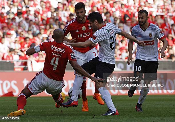 Benfica's Brazilian defender Anderson da Silva "Luisao" and Greek midfielder Andreas Samaris vie with Penafiel's midfielder Bruno Braga past...
