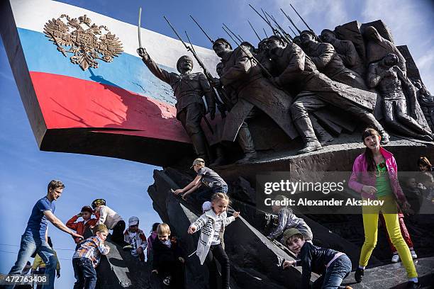 Kids play on the Memorial to the Heroes of WW1 in the Victory Park during celebrations marking the 70th anniversary of the victory over Nazi Germany...