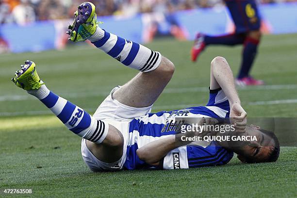 Real Sociedad's defender Mikel Gonzalez reacts after falling on the ground during the Spanish league football match FC Barcelona vs Real Sociedad de...