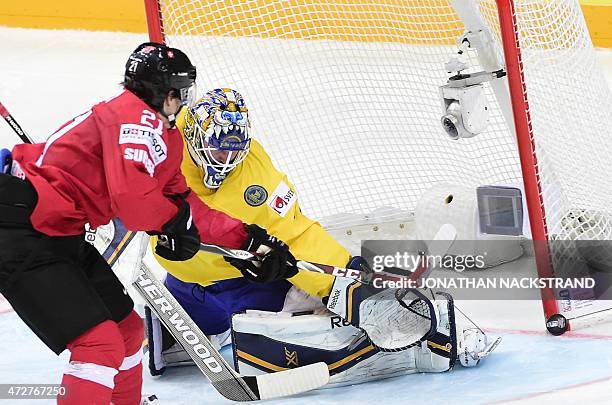 Forward Kevin Fiala of Switzerland hits the post as he shoots towards goalkeeper Jhonas Enroth of Sweden during the group A preliminary round match...