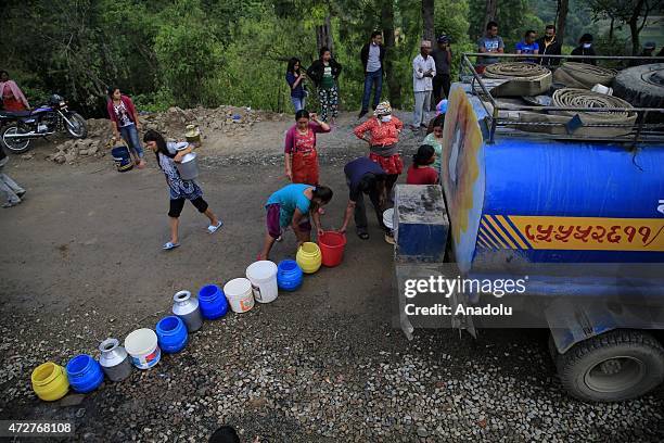 Nepalese wait to fill buckets with water in Bungamati neighborhood Kathmandu, Nepal on May 9, 2015. The number of the dead in the aftermath of...