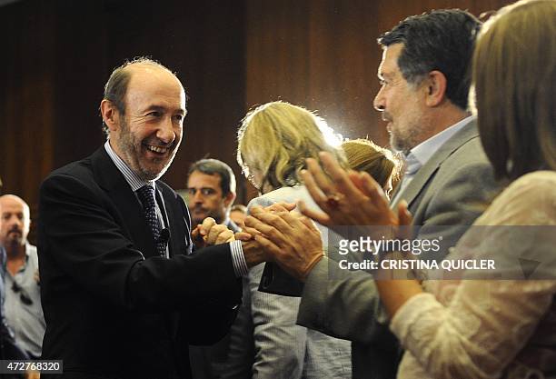Spain's Deputy Prime Minister and candidate for the March 2012 general elections Alfredo Perez Rubalcaba shakes ahands with PSOE activists at the end...