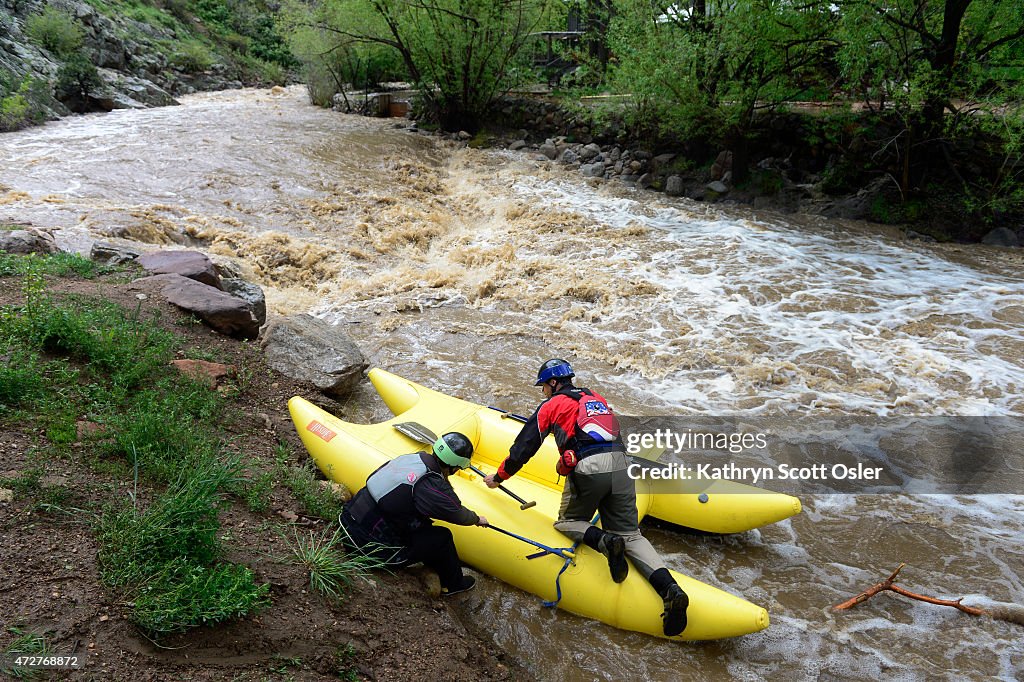 People take advantage of the high, fast-moving Boulder creek right at the the mouth of Boulder Canyon.