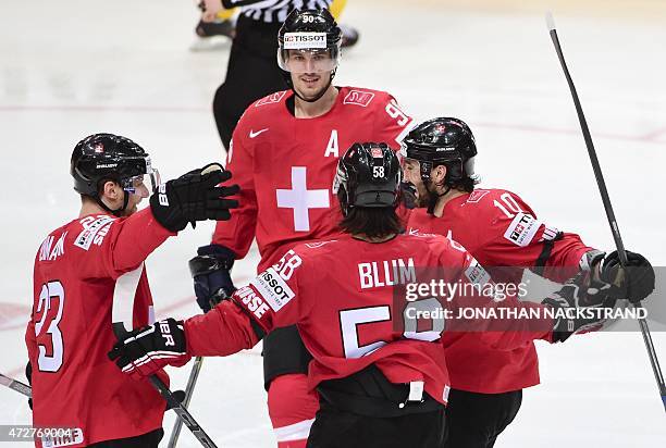 Forward Simon Bodenmann of Switzerland celebrates with his teammates after scoring a goal during the group A preliminary round match Sweden vs...