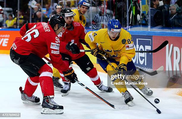 Oscar Klefbom of Sweden and Damien Brunner of Switzerland battle for the puck during the IIHF World Championship group A match between Austria and...