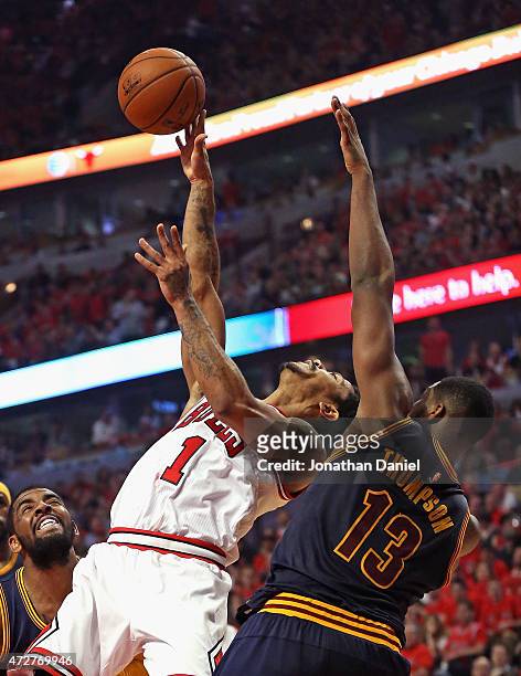 Derrick Rose of the Chicago Bulls tries to get off a shot under pressure from Tristan Thompson of the Cleveland Cavaliers in Game Three of the...