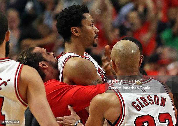 Joakim Noah, Derrick Rose and Taj Gibson of the Chicago Bulls celebrate Rose's game-wiinning shot against the Cleveland Cavaliers in Game Three of...