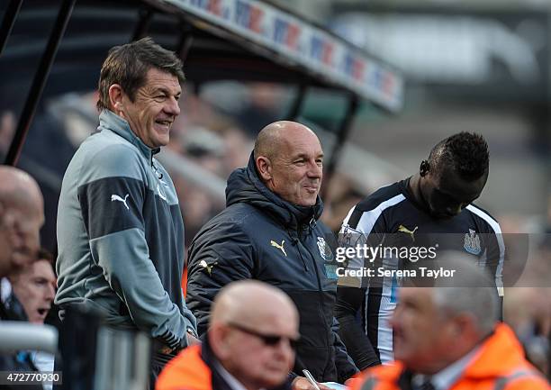 Newcastle Head Coach John Carver stands in the dugout out with Coach Steve Stone and Papiss Cisse during the Barclays Premier League match between...