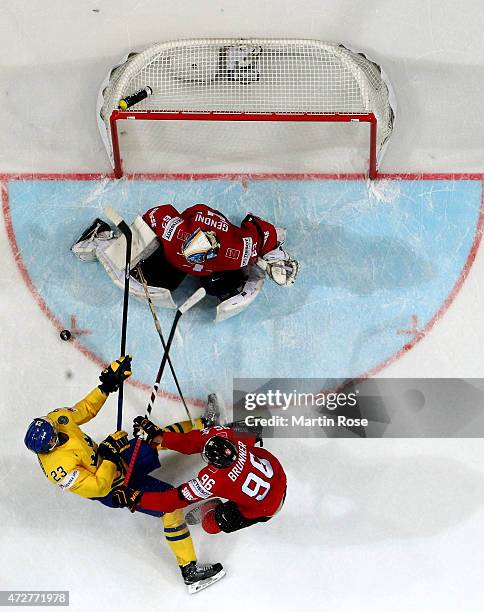 Oliver Ekman Larsson of Sweden fails to score over Leonardo Genoni, goaltender of Switzerland during the IIHF World Championship group A match...