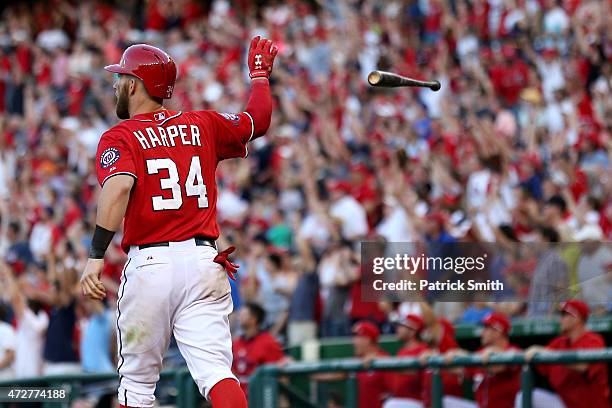 Bryce Harper of the Washington Nationals tosses his bat after hitting a walk off home run in the ninth inning against the Atlanta Braves at Nationals...