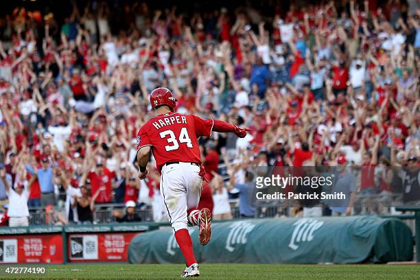 Bryce Harper of the Washington Nationals celebrates as he rounds the bases after hitting a walk off home run in the ninth inning against the Atlanta...