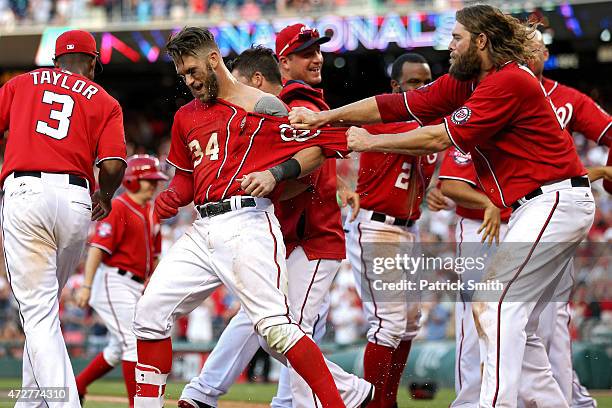 Bryce Harper of the Washington Nationals celebrates with teammates after hitting a walk off home run in the ninth inning against the Atlanta Braves...