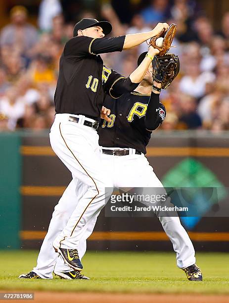 Jordy Mercer and Neil Walker of the Pittsburgh Pirates attempt to make a catch in the fourth inning against the St Louis Cardinals during the game at...