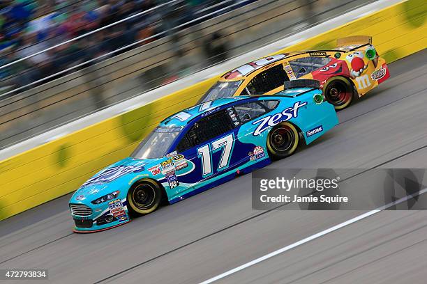 Ricky Stenhouse Jr., driver of the Zest Ford, leads Erik Jones, driver of the M&M's Red Nose Day Toyota, during the NASCAR Sprint Cup Series...