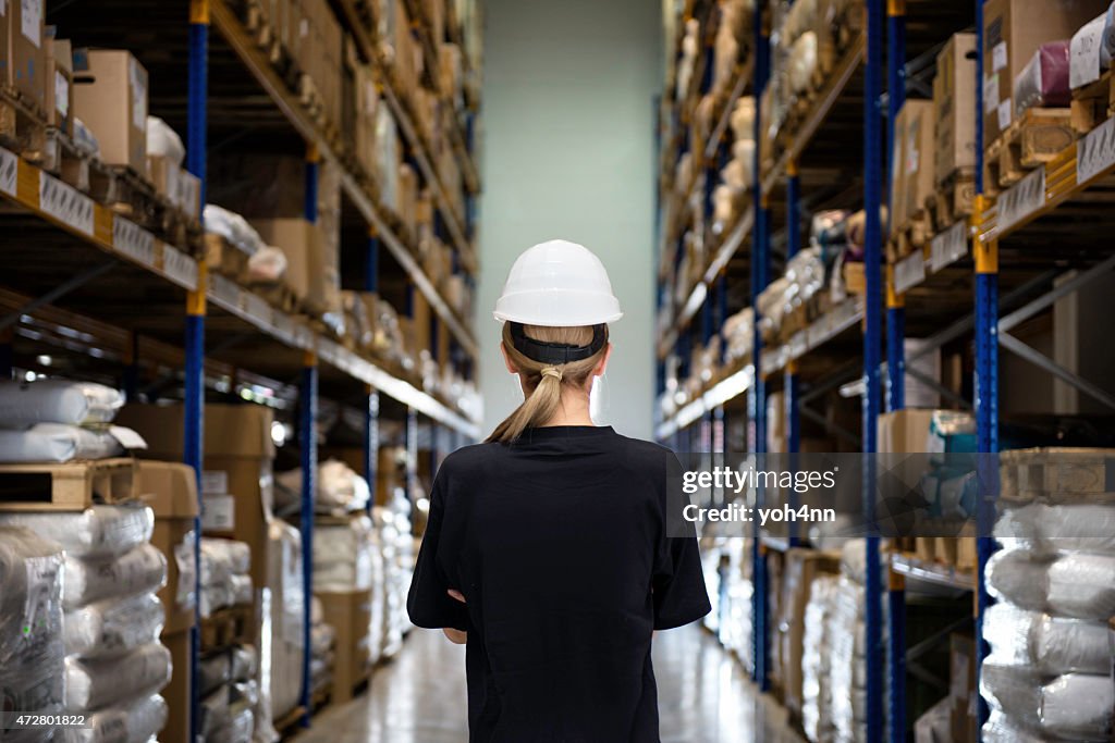 Rear view of woman in warehouse