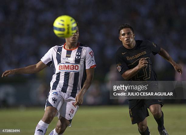 Alexander Mejia of Monterrey vie for the ball with Javier Cortes of Pumas, during their 2015 Mexican Clausura tournament football match in Monterrey,...
