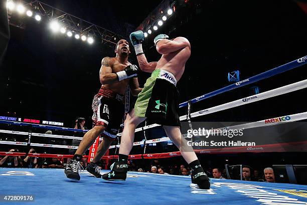 Canelo Alvarez of Mexico delivers a punch to James Kirkland during their super welterweight bout at Minute Maid Park on May 9, 2015 in Houston, Texas.