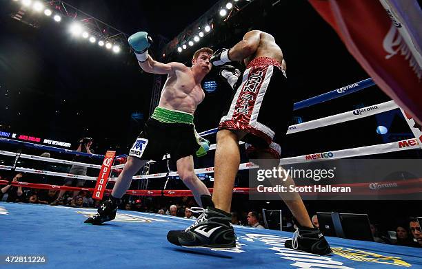 Canelo Alvarez of Mexico delivers a punch to James Kirkland during their super welterweight bout at Minute Maid Park on May 9, 2015 in Houston, Texas.