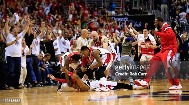 Paul Pierce of the Washington Wizards lays on the ground and celebrates with teammates after hitting the game winning shot to give the Wizards a...