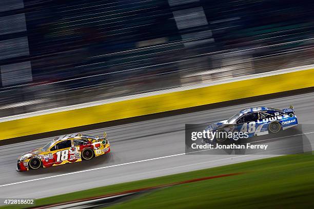 Erik Jones, driver of the M&M's Red Nose Day Toyota, leads Jimmie Johnson, driver of the Lowe's Chevrolet, during the NASCAR Sprint Cup Series...