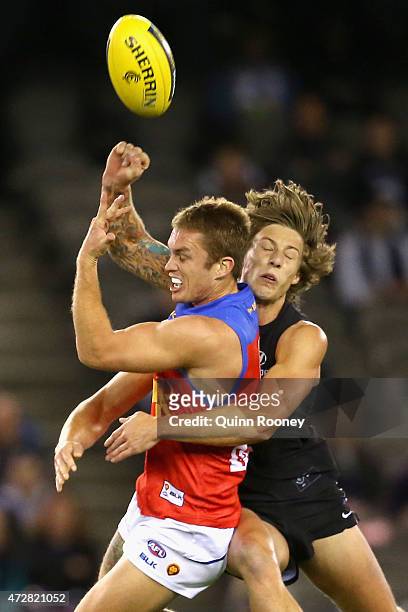 Dayne Beams of the Lions handballs whilst being tackled Mark Whiley of the Blues during the round six AFL match between the Carlton Blues and the...