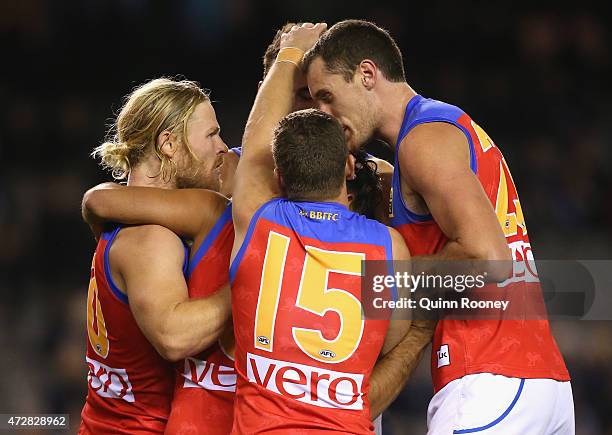 Allen Christensen of the Lions is congratulated by team mates after kicking a goal during the round six AFL match between the Carlton Blues and the...