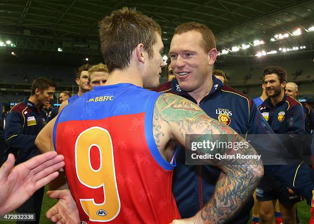 Dayne Beams and Justin Leppitsch the coach of the Lions celebrate winning the round six AFL match between the Carlton Blues and the Brisbane Lions at...