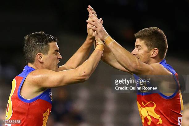Tom Rockliff of the Lions is congratulated by Dayne Zorko after kicking a goal during the round six AFL match between the Carlton Blues and the...