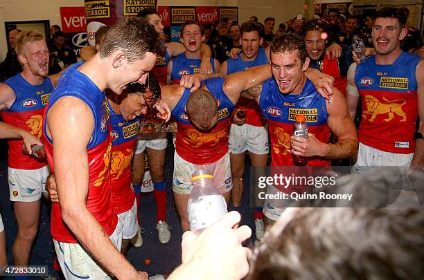 Harris Andrews, Allen Christensen, Mitch Robinson and Dayne Beams of the Lions sing the song in the rooms after winning the round six AFL match...