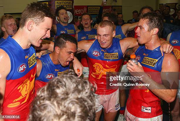 Harris Andrews, Allen Christensen, Mitch Robinson and Dayne Beams of the Lions sing the song in the rooms after winning the round six AFL match...