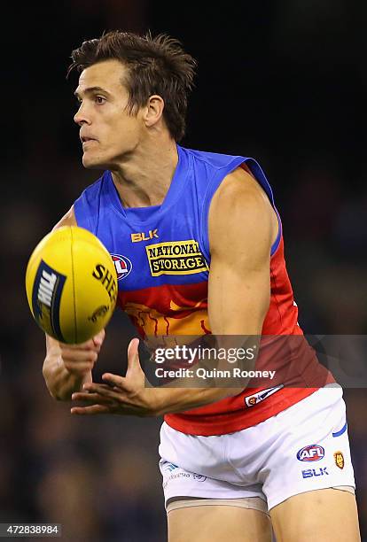 Jed Adcock of the Lions handballs during the round six AFL match between the Carlton Blues and the Brisbane Lions at Etihad Stadium on May 10, 2015...