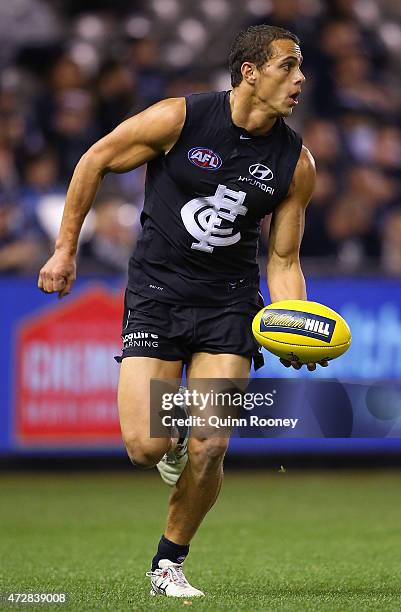 Ed Curnow of the Blues handballs during the round six AFL match between the Carlton Blues and the Brisbane Lions at Etihad Stadium on May 10, 2015 in...