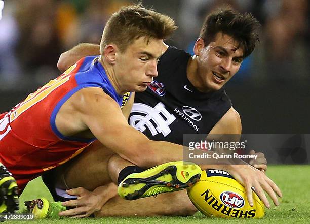 Harris Andrews of the Lions and Blaine Boekhorst of the Blues compete for the ball during the round six AFL match between the Carlton Blues and the...