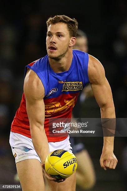 Jack Redden of the Lions handballs during the round six AFL match between the Carlton Blues and the Brisbane Lions at Etihad Stadium on May 10, 2015...