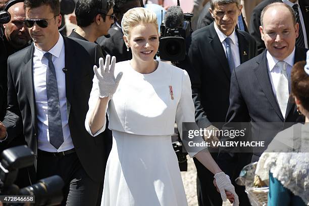 Prince Albert II of Monaco and his wife Princess Charlene greet the crowd outside the cathedral after the baptism of their twins Prince Jacques and...