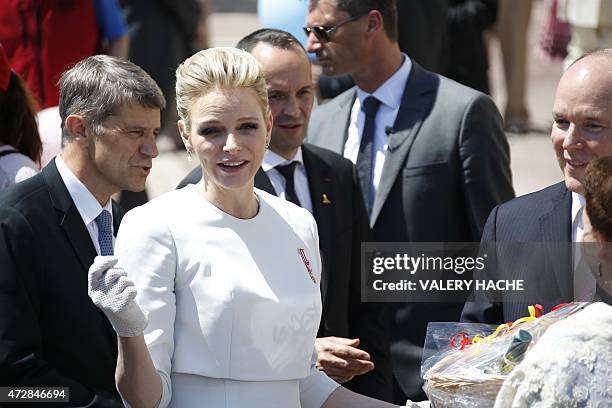 Prince Albert II of Monaco and his wife Princess Charlene greet the crowd outside the cathedral after the baptism of their twins Prince Jacques and...