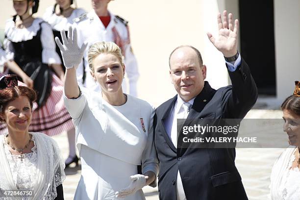 Prince Albert II of Monaco and his wife Princess Charlene greet the crowd outside the cathedral after the baptism of their twins Prince Jacques and...