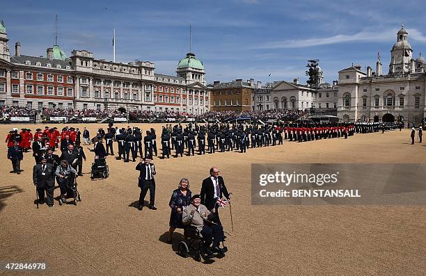 War veterans arrive as members of the armed forces muster on Horse Guards Parade in central London on May 10, 2015 during an armed forces and...