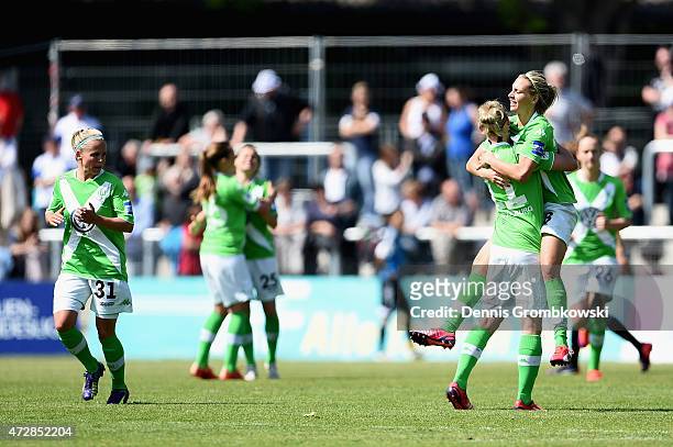 Lena Goessling and Alexandra Popp of VfL Wolfsburg celebrate as Martina Mueller scores their first goal during the Allianz Frauen-Bundesliga match...