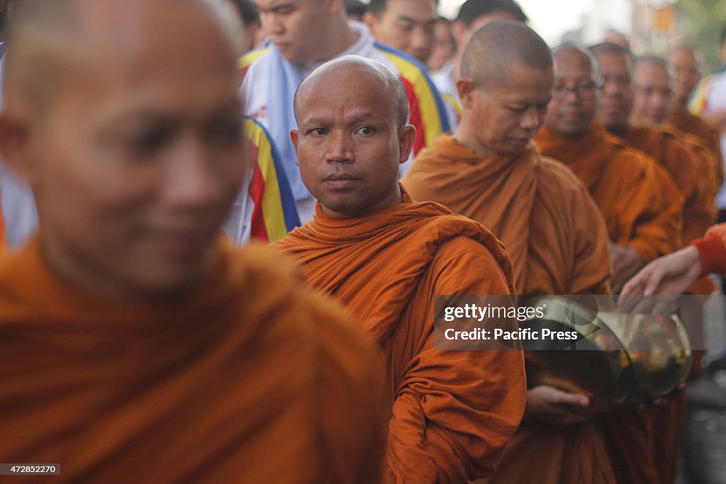 Buddhist monks attend the Pindapata procession ahead Vesak...