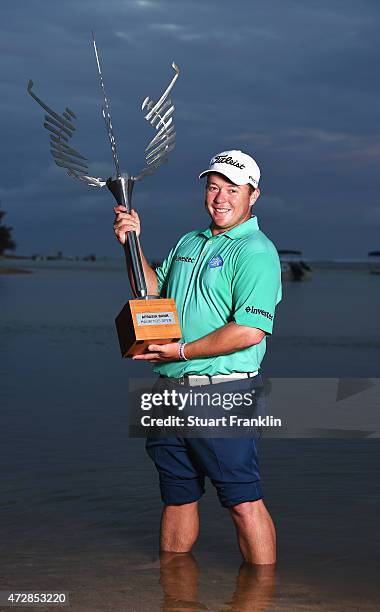 George Coetzee of South Africa with the trophy after winning the AfrAsia Bank Mauritius Open at Heritage Golf Club on May 10, 2015 in Bel Ombre,...