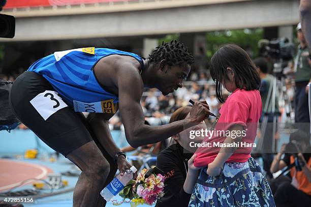 Hua Wilfried Koffi,winner of the 100m signs an autograph during the Seiko Golden Grand Prix Tokyo 2015 at Todoroki Stadium on May 10, 2015 in...