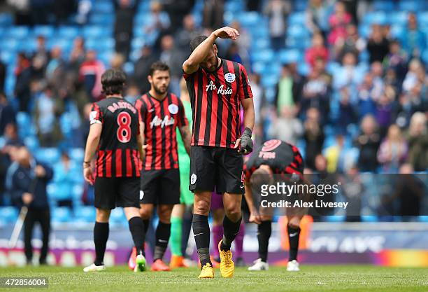 Dejected Steven Caulker of QPR and teammates react following their team's relegation during the Barclays Premier League match between Manchester City...