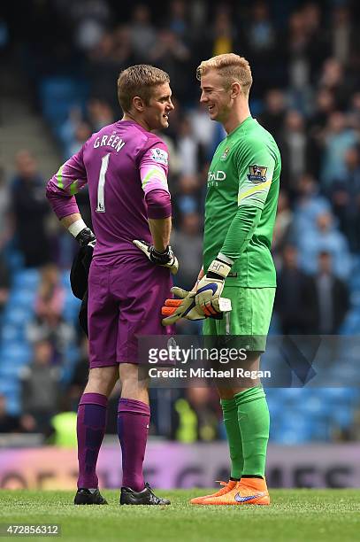 Dejected goalkeeper Robert Green of QPR is consoled by Joe Hart of Manchester City following his team's relegation during the Barclays Premier League...