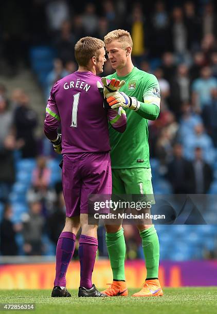 Dejected goalkeeper Robert Green of QPR is consoled by Joe Hart of Manchester City following his team's relegation during the Barclays Premier League...