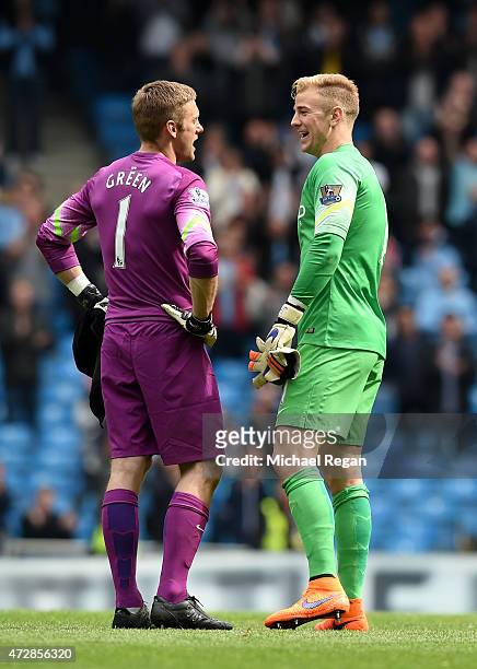 Dejected goalkeeper Robert Green of QPR is consoled by Joe Hart of Manchester City following his team's relegation during the Barclays Premier League...