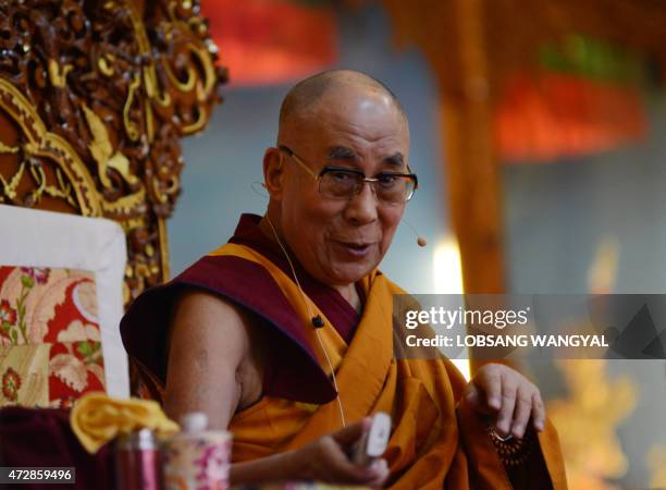 Tibetan spiritual leader His Holiness the Dalai Lama speaks during a teaching session at Gyuto Monastery in the Indian town of Dharamshala on May 10,...